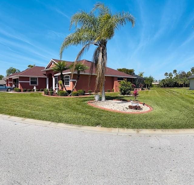 ranch-style house with stucco siding and a front yard