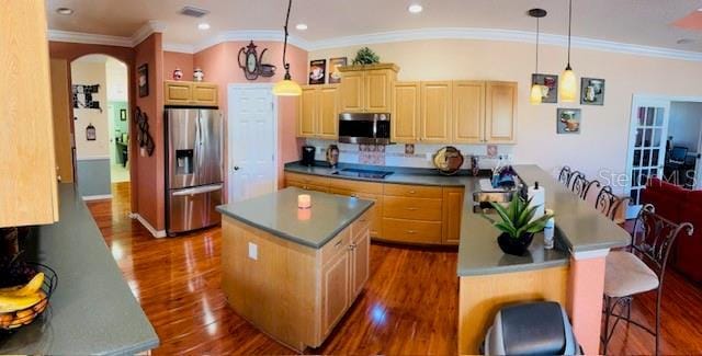 kitchen featuring dark wood-style floors, visible vents, appliances with stainless steel finishes, and a center island