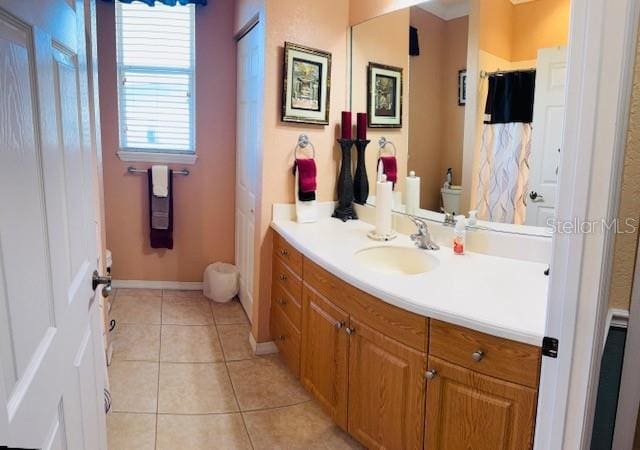 bathroom with tile patterned flooring, vanity, and baseboards