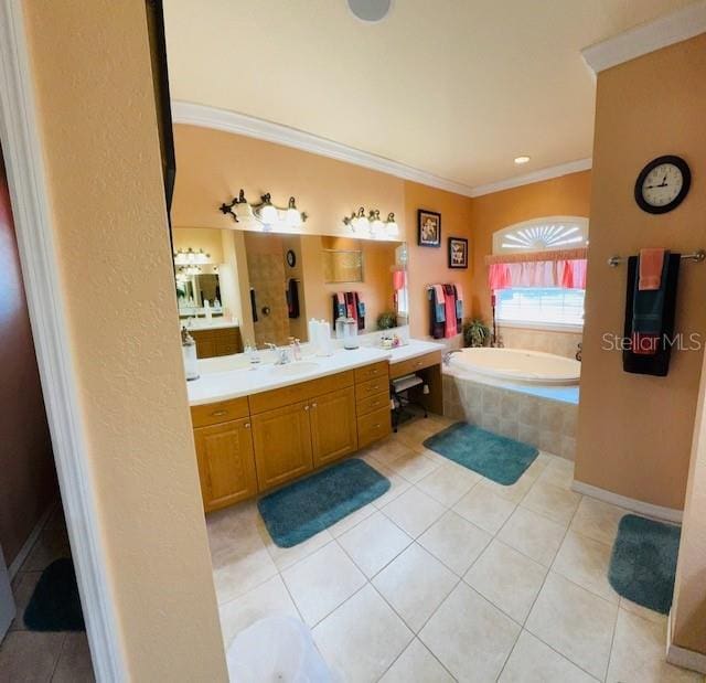 bathroom with tile patterned flooring, crown molding, a garden tub, and vanity