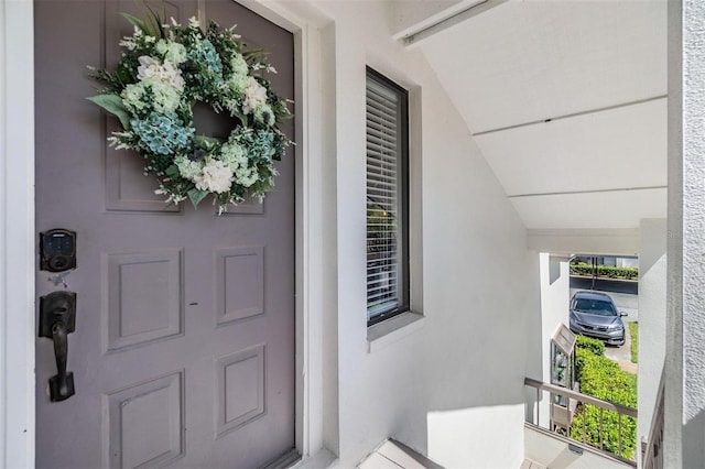 entrance to property with stucco siding