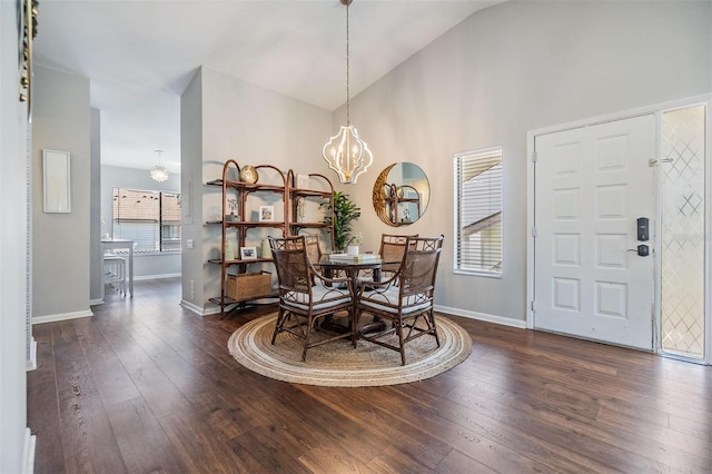 dining room with baseboards, a notable chandelier, dark wood-style floors, and high vaulted ceiling