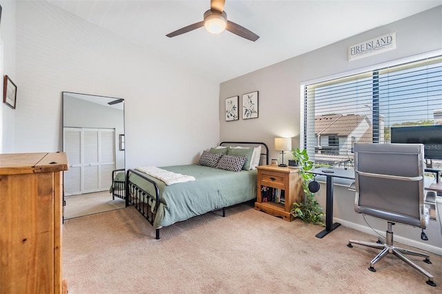 carpeted bedroom featuring vaulted ceiling, a ceiling fan, and baseboards