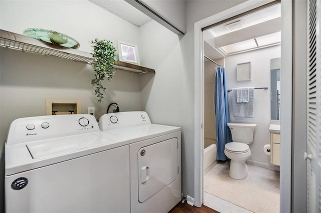 clothes washing area featuring washer and dryer and laundry area