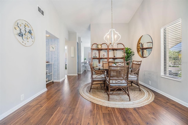 dining room featuring an inviting chandelier, wood finished floors, visible vents, and baseboards