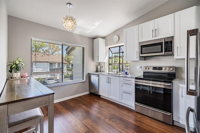 kitchen featuring dark wood-style flooring, a sink, vaulted ceiling, white cabinets, and appliances with stainless steel finishes