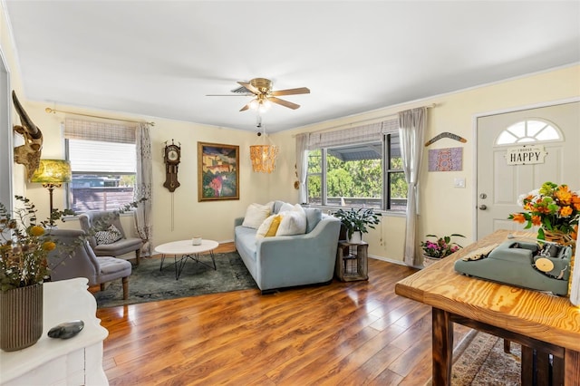 living area with hardwood / wood-style floors, plenty of natural light, and a ceiling fan