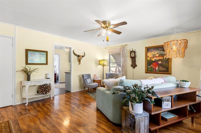 living room featuring wood-type flooring and ceiling fan with notable chandelier