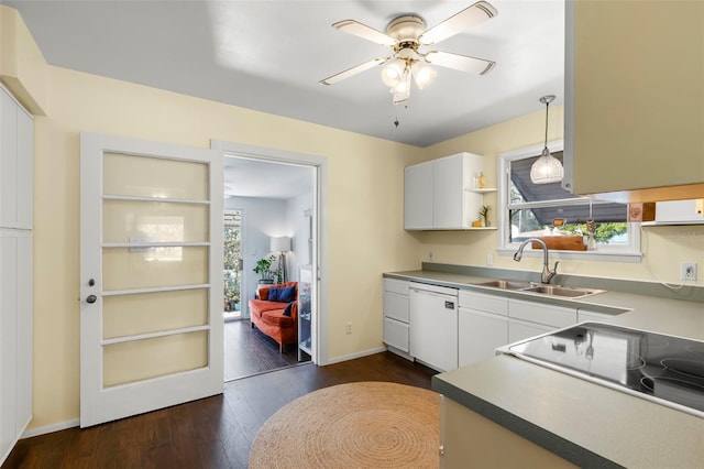 kitchen featuring a sink, ceiling fan, dishwasher, hanging light fixtures, and dark wood-style flooring