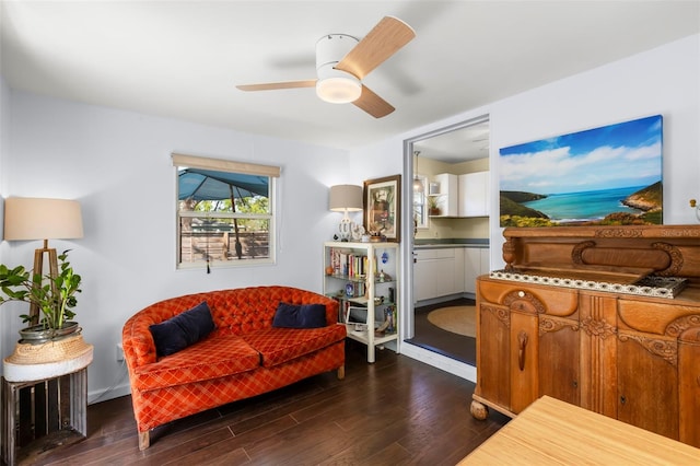 living room featuring a ceiling fan and dark wood-style flooring