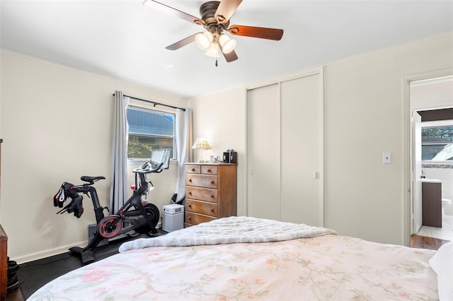 bedroom featuring a closet, baseboards, and a ceiling fan