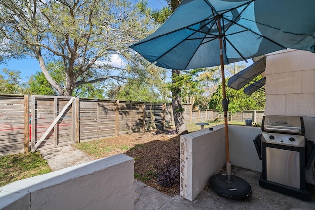 view of patio / terrace with a grill and fence