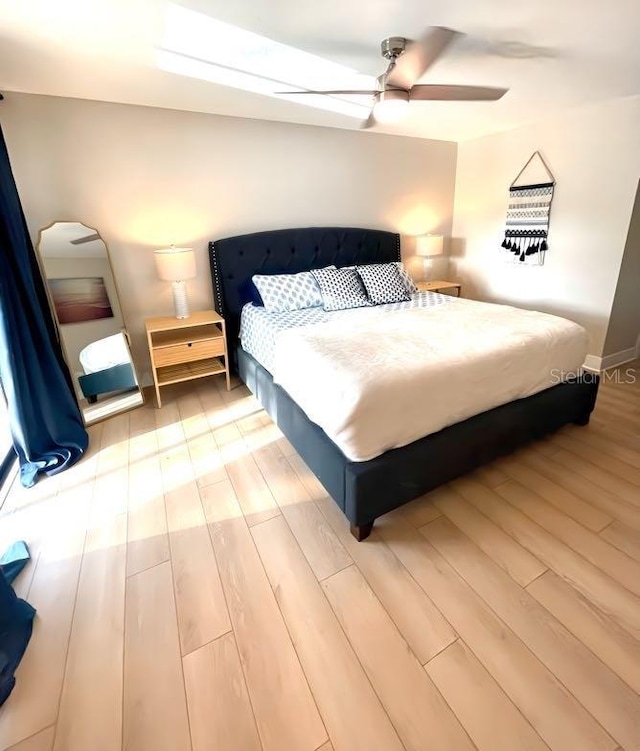 bedroom with light wood finished floors and ceiling fan