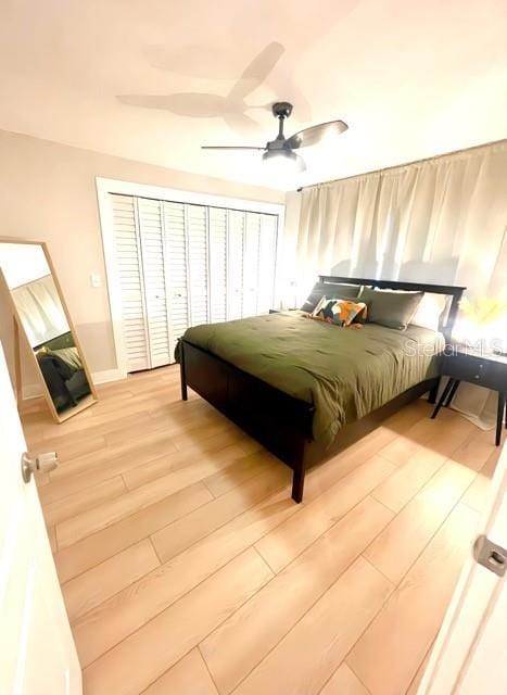 bedroom with a ceiling fan and wood finished floors