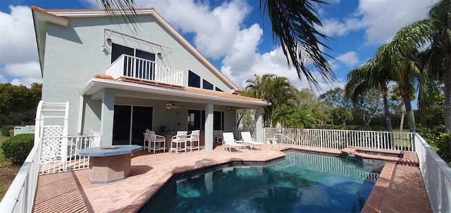7279 Maidencane Ct, Seminole, FL 33777 - rear view of house with a balcony, fence, stucco siding, ceiling fan, and a patio area