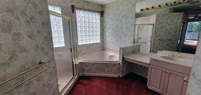 7279 Maidencane Ct, Seminole, FL 33777 - full bathroom with a stall shower, wallpapered walls, vanity, and a garden tub