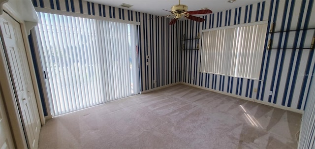 7279 Maidencane Ct, Seminole, FL 33777 - carpeted spare room with visible vents, ceiling fan, and wallpapered walls