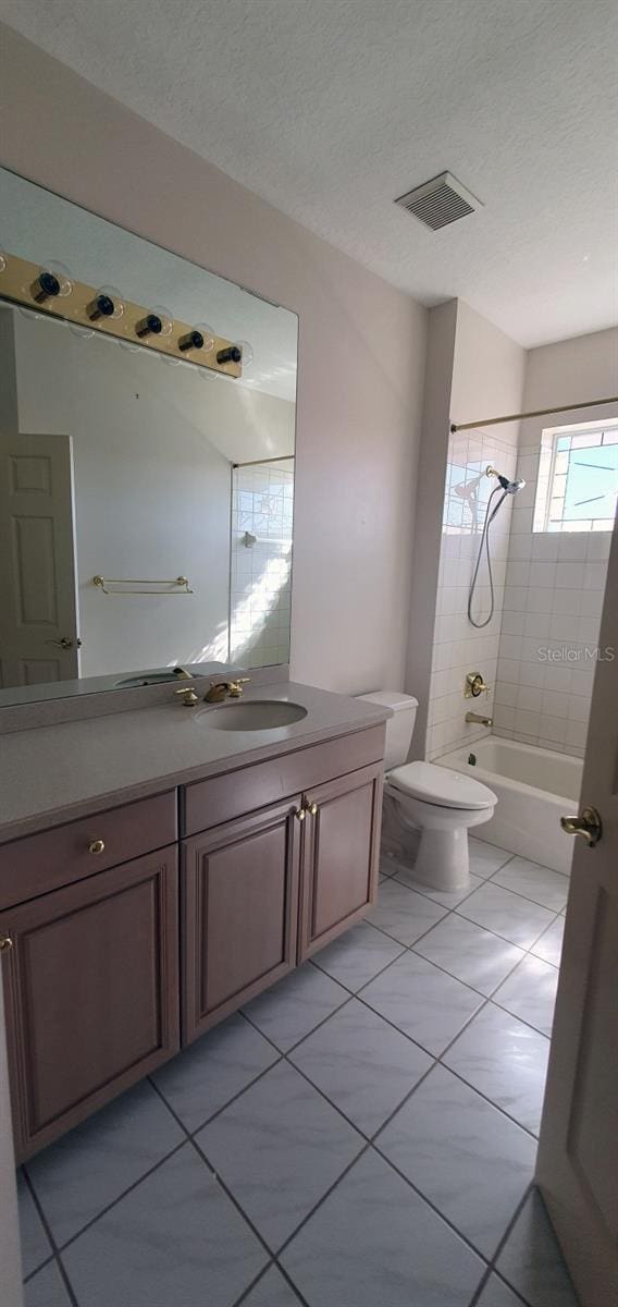 7279 Maidencane Ct, Seminole, FL 33777 - full bath with visible vents, toilet, vanity, bathtub / shower combination, and a textured ceiling