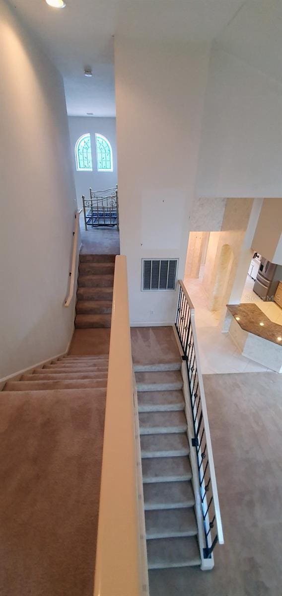 7279 Maidencane Ct, Seminole, FL 33777 - stairway with visible vents and carpet floors
