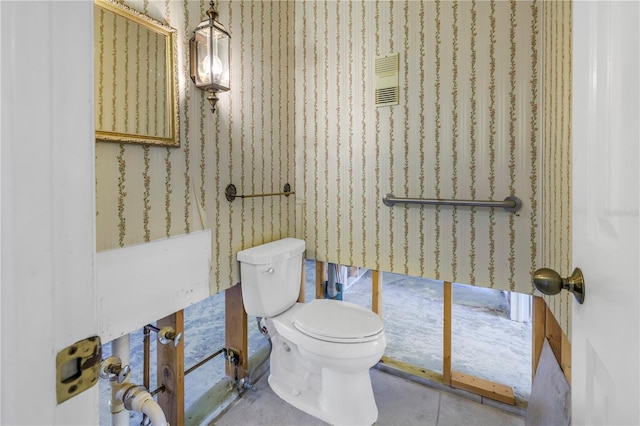 half bathroom with toilet and visible vents