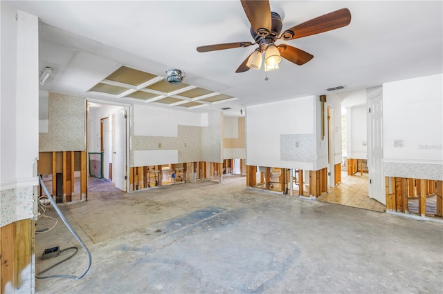 interior space featuring visible vents, a ceiling fan, unfinished concrete floors, and wallpapered walls