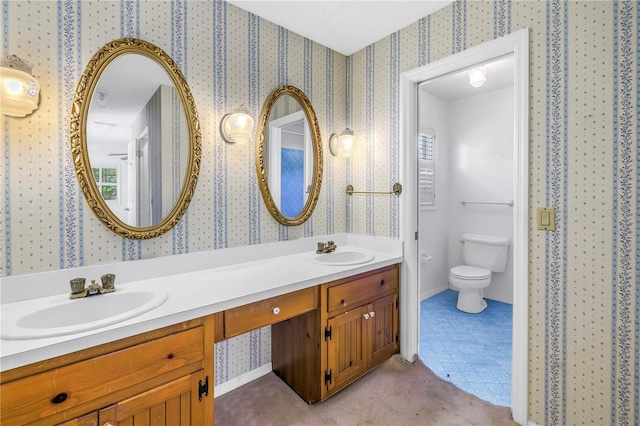 full bath featuring a sink, toilet, and wallpapered walls