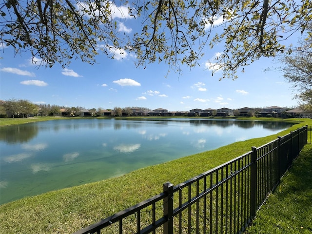 property view of water featuring fence