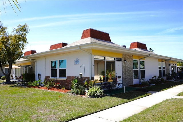 exterior space featuring a yard and stucco siding