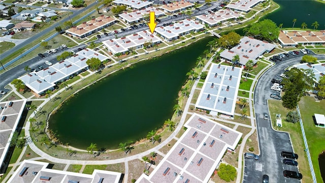 drone / aerial view featuring a water view and a residential view