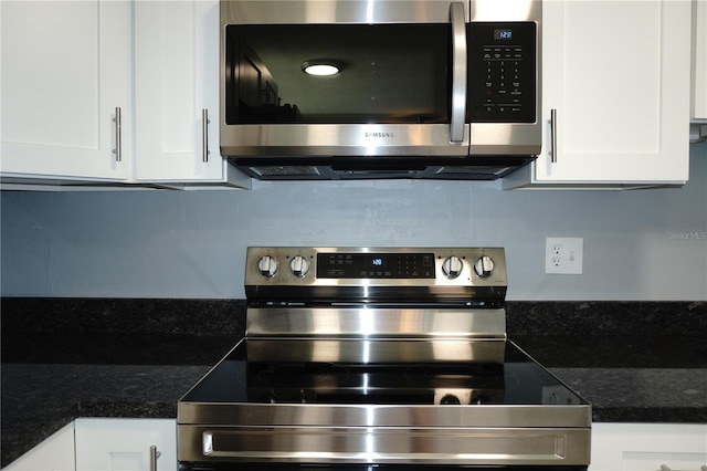 details featuring stainless steel appliances, mail area, and white cabinets