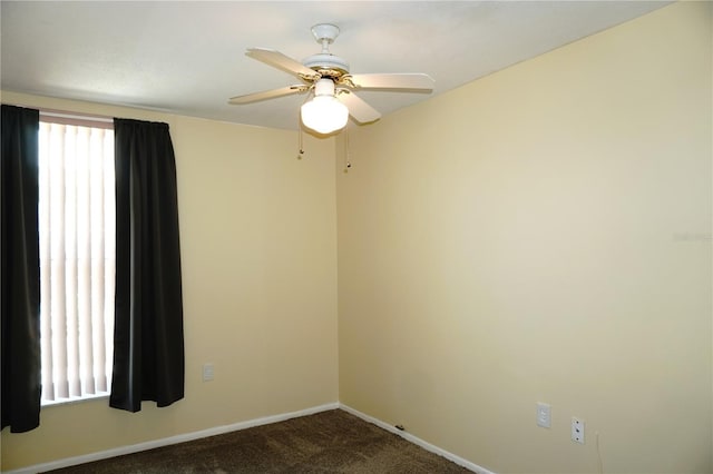 empty room featuring baseboards, carpet floors, and a ceiling fan