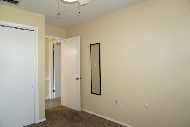 unfurnished bedroom with a closet, visible vents, baseboards, and carpet floors