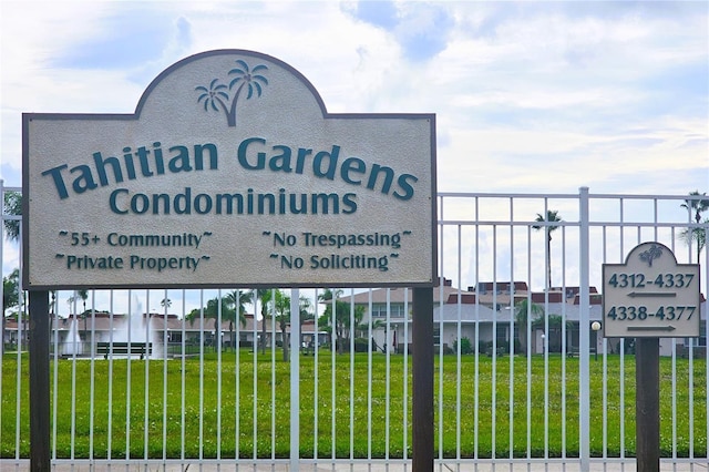 community sign with a yard and fence