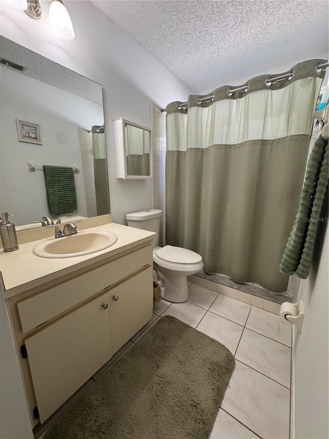 bathroom with visible vents, toilet, a textured ceiling, tile patterned flooring, and vanity