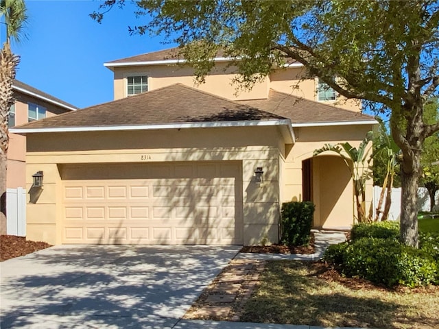 view of front of property with concrete driveway, stucco siding, a garage, and a shingled roof