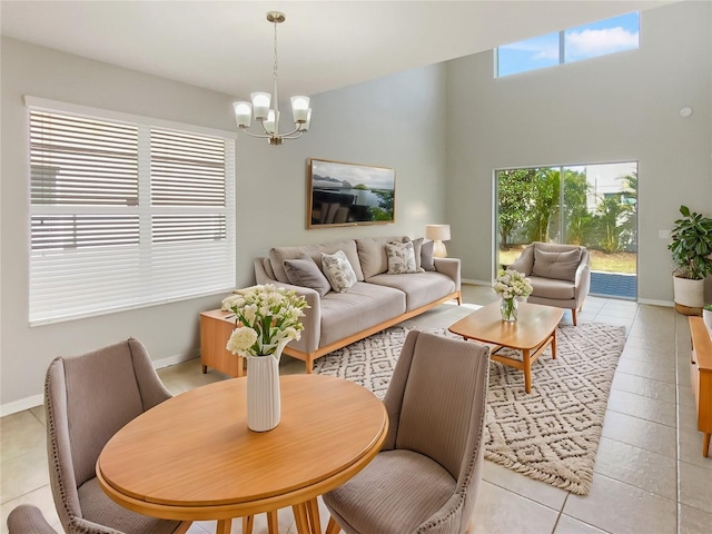 living room featuring baseboards, a notable chandelier, and light tile patterned flooring