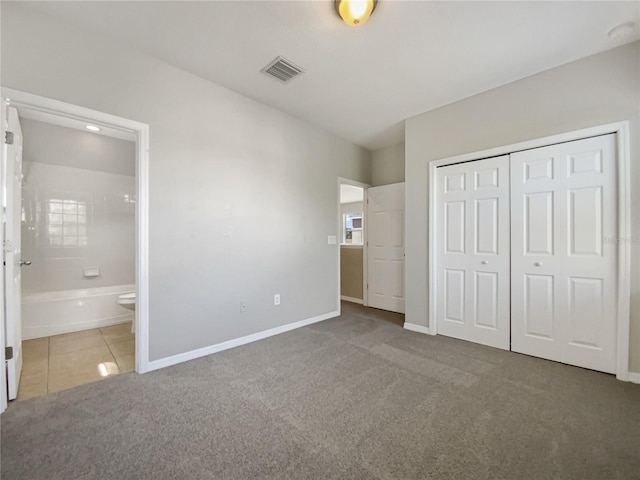 unfurnished bedroom featuring visible vents, connected bathroom, carpet floors, a closet, and baseboards