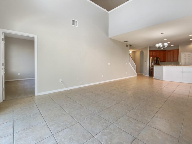 unfurnished living room featuring stairs, light tile patterned floors, baseboards, and a chandelier