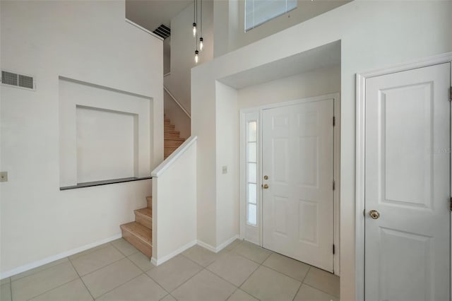 5014 Sterling Manor Dr, Tampa, FL 33647 - foyer entrance with stairway, light tile patterned flooring, and baseboards