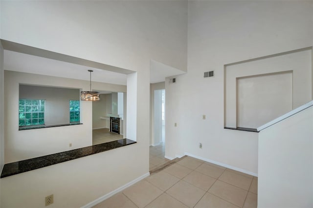 5014 Sterling Manor Dr, Tampa, FL 33647 - unfurnished room with baseboards, a fireplace, and a chandelier