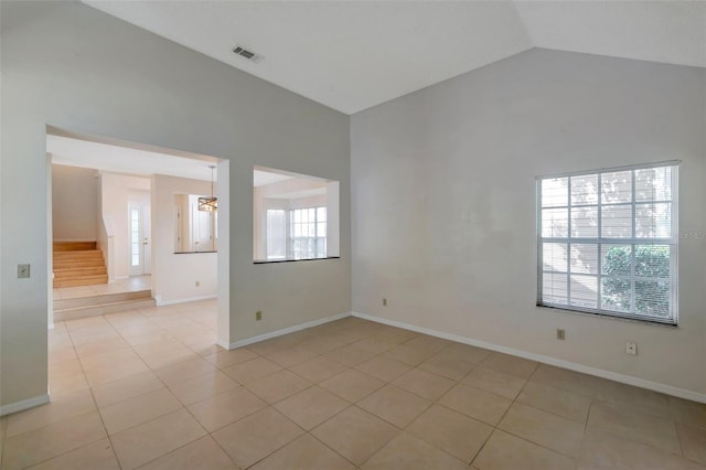 5014 Sterling Manor Dr, Tampa, FL 33647 - spare room featuring light tile patterned floors, vaulted ceiling, stairs, and baseboards