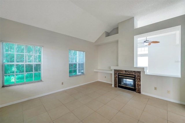 5014 Sterling Manor Dr, Tampa, FL 33647 - unfurnished living room with vaulted ceiling, a premium fireplace, light tile patterned flooring, ceiling fan, and baseboards