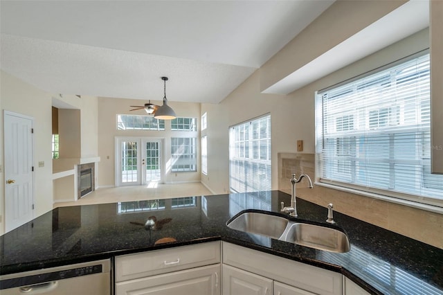 5014 Sterling Manor Dr, Tampa, FL 33647 - kitchen with a sink, dishwasher, open floor plan, a ceiling fan, and white cabinetry