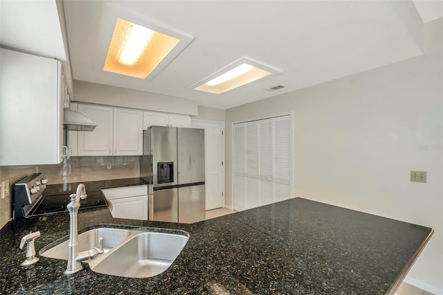5014 Sterling Manor Dr, Tampa, FL 33647 - kitchen with stainless steel appliances, tasteful backsplash, extractor fan, white cabinetry, and dark stone countertops