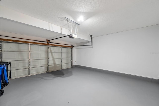 5014 Sterling Manor Dr, Tampa, FL 33647 - garage featuring a garage door opener and baseboards