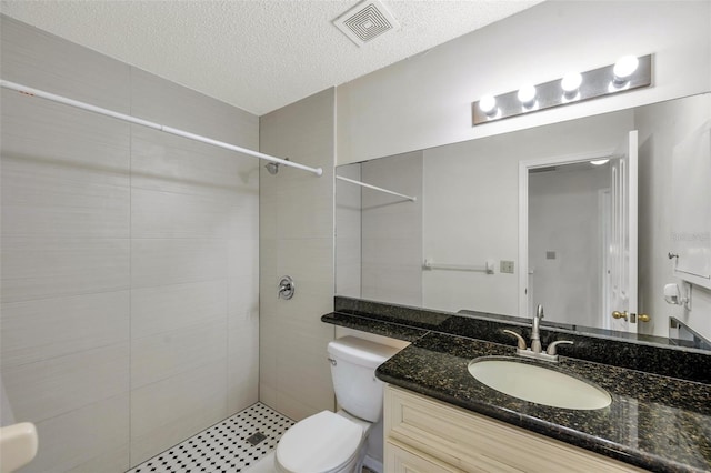 5014 Sterling Manor Dr, Tampa, FL 33647 - bathroom with toilet, a tile shower, vanity, and a textured ceiling