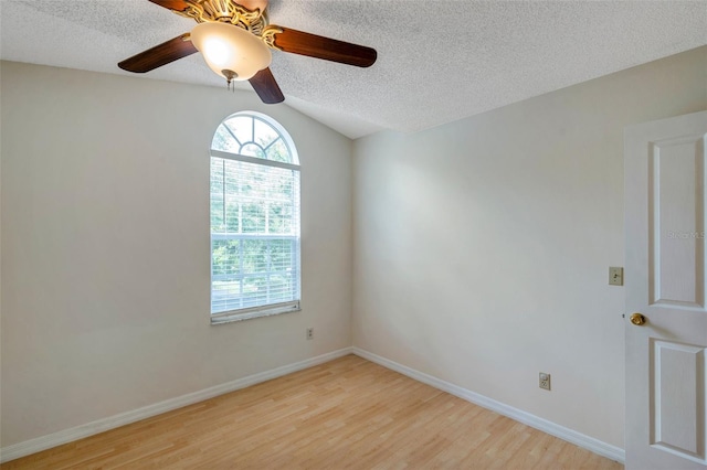 5014 Sterling Manor Dr, Tampa, FL 33647 - empty room featuring light wood-type flooring, ceiling fan, a textured ceiling, vaulted ceiling, and baseboards