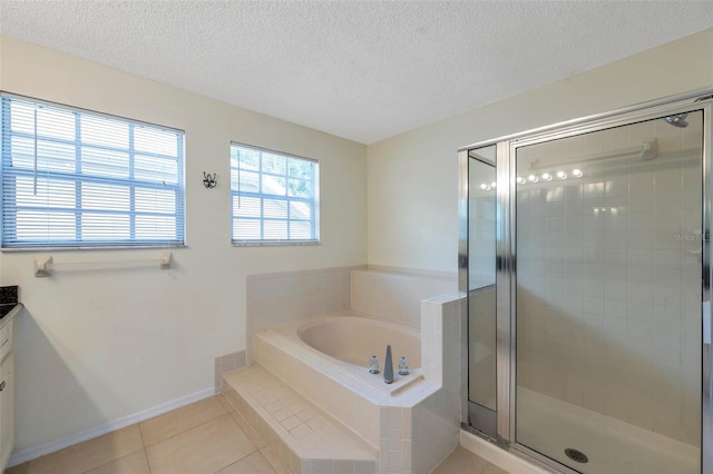5014 Sterling Manor Dr, Tampa, FL 33647 - bathroom featuring tile patterned flooring, a garden tub, a textured ceiling, a shower stall, and vanity