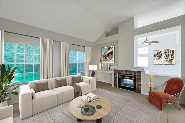5014 Sterling Manor Dr, Tampa, FL 33647 - living room with light tile patterned floors, a premium fireplace, lofted ceiling, and a ceiling fan