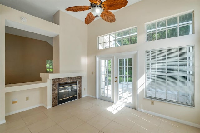 5014 Sterling Manor Dr, Tampa, FL 33647 - unfurnished living room with a high ceiling, a ceiling fan, tile patterned flooring, baseboards, and a fireplace